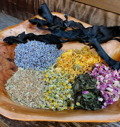 Luxurious spiritual bath products and cleansing washes displayed with fresh roses, crystals, and candles on an elegant wooden surface, creating a serene spa-like setting for energy cleansing and transformation rituals.