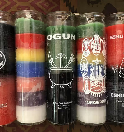Elegant spiritual candles in beautiful glass containers arranged with fresh roses, crystals, and oils on a wooden table, creating a serene atmosphere for manifestation rituals and intention setting.